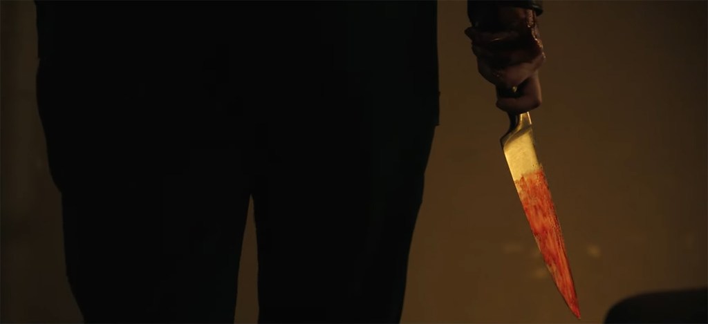 Woman holding a bloody knife. 