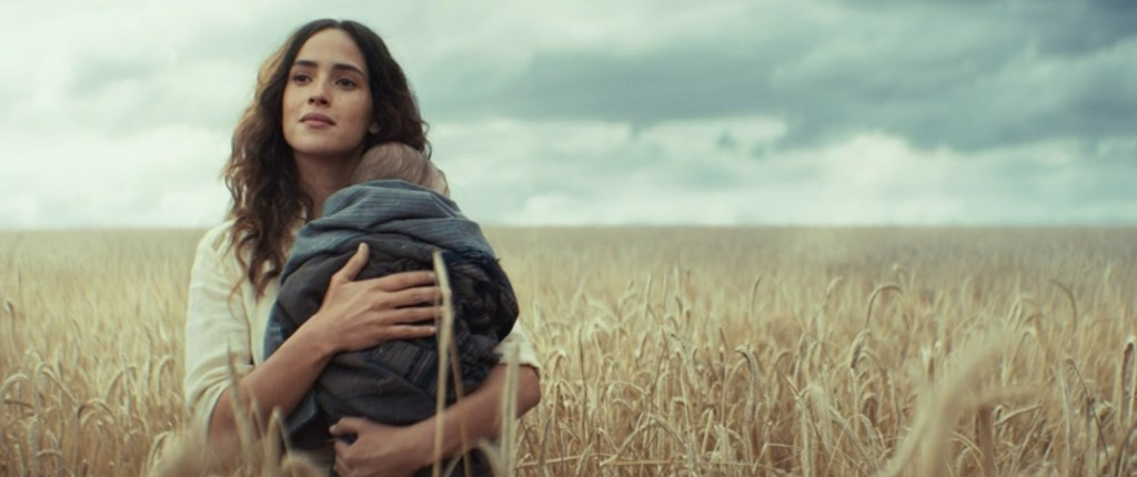 Bix in a wheat field with her and Andor's son. 