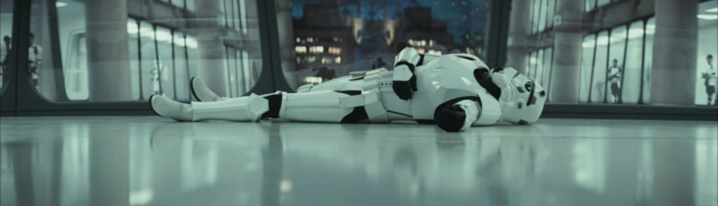 A dead Stormtrooper lies on the ground.