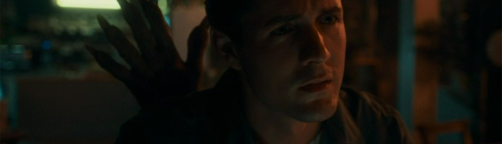 A monster hand appears behind Conrad.