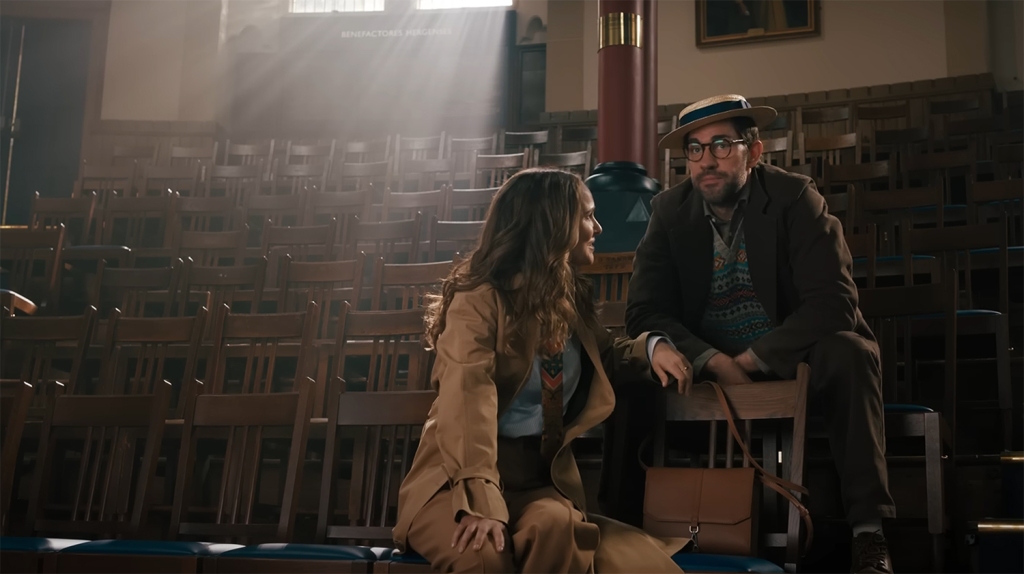 Brother and sister siting on some seats in an auditorium. 