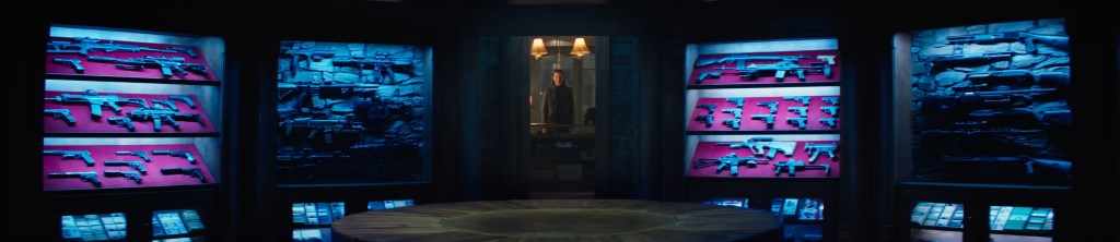 Eve walks into a gun room. 