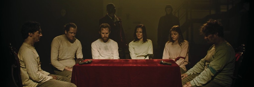 Prisoners around a table. 