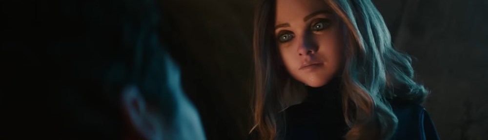 M3GAN staring over someone as they sleep.