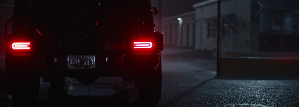 A truck pulls up to the storage lot at night. 