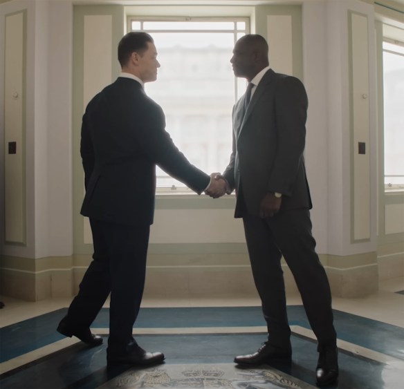 John Cena and Idris Elba shake hands.
