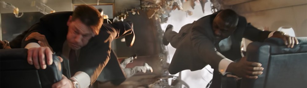 John Cena and Idris Elba hold onto seats to stop being blown out of the plane.