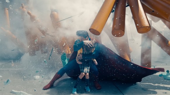 Superman protects a little girl from exploding cylinders.