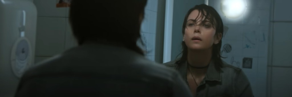 Charlize Theron staring into a mirror.