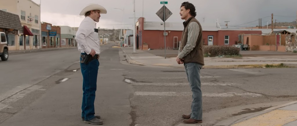 Joaquin Phoenix and Pedro Pascal stand off against each other.