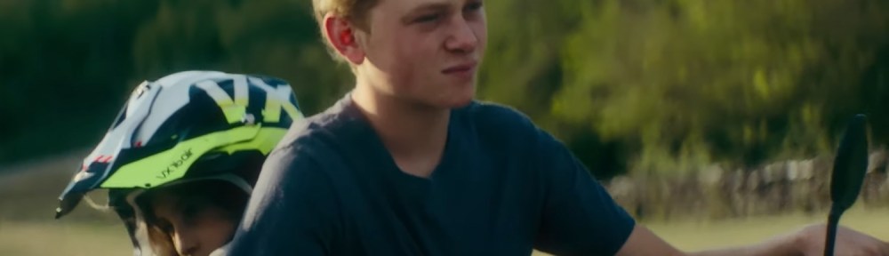 Totone riding his sister to school on a dirt bike.