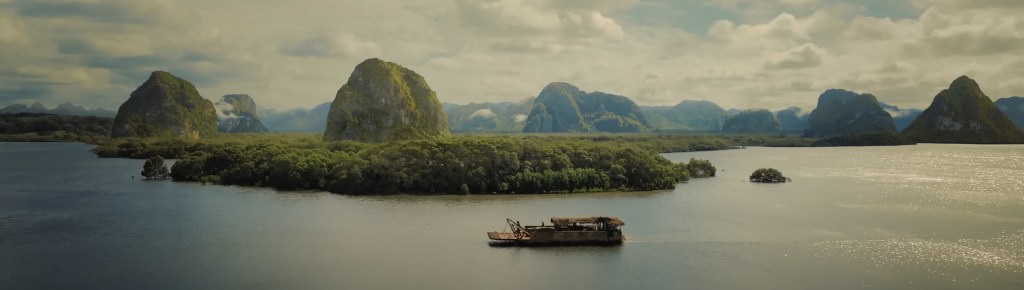 A boat glides up a Vietnamese river.