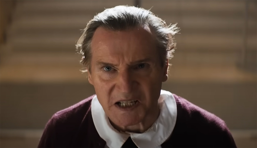 Liam Neeson in child's clothes. 