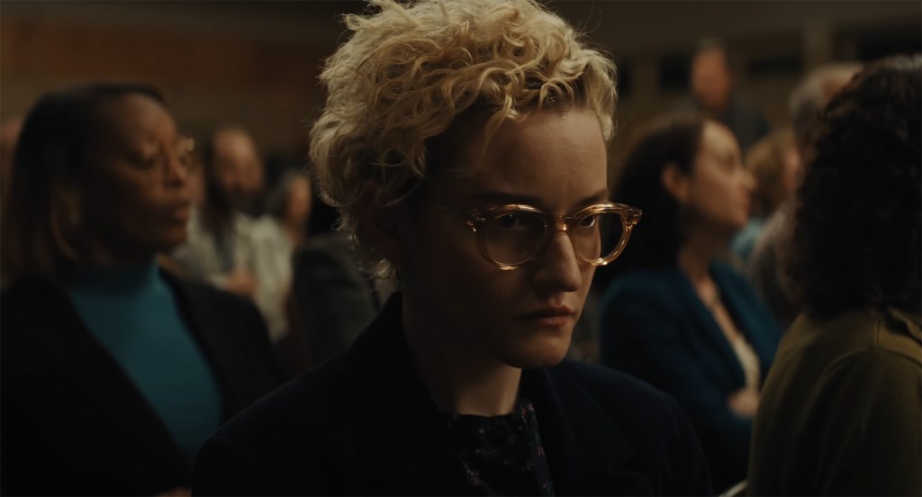 Julia Garner as Justine Gandy in a school meeting.