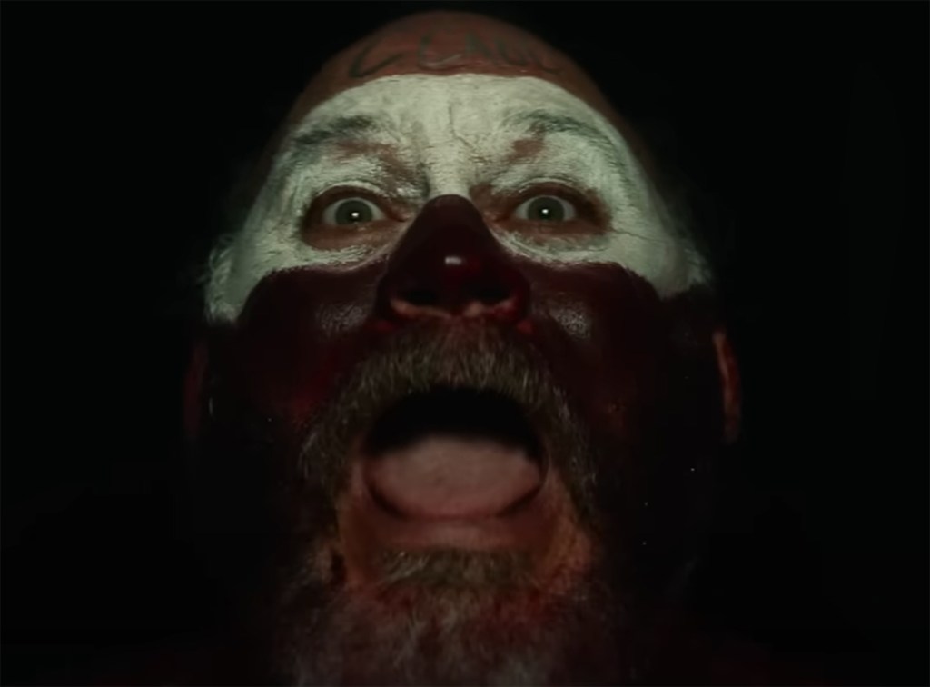 A man in face paint screams. 