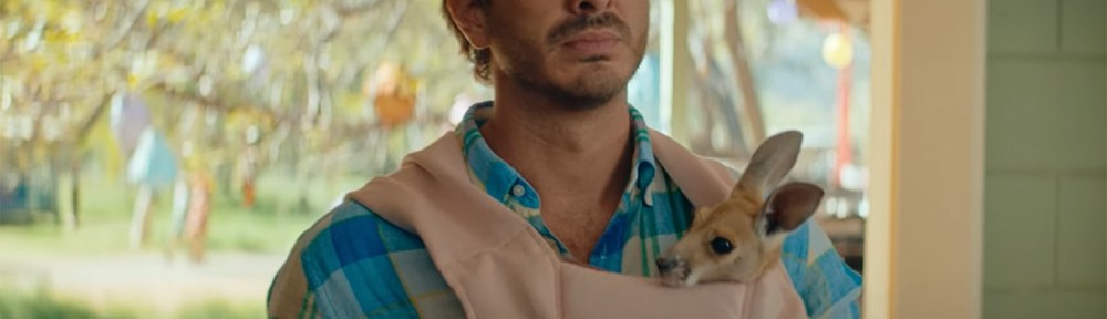 Ryan Corr with a joey in a baby pouch.