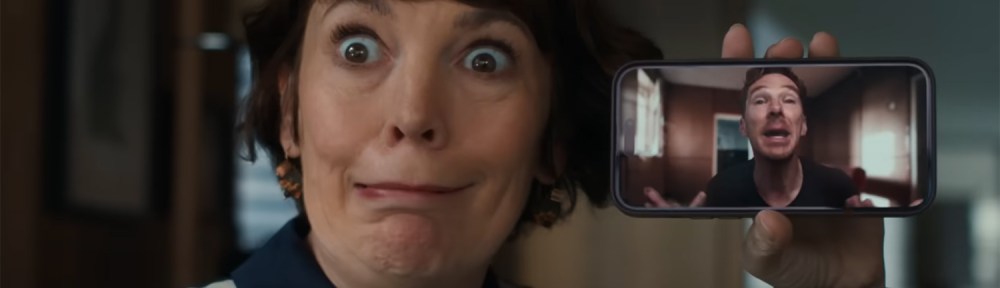 Olivia Colman holding Benedict Cumberbatch on a mobile phone voice call.