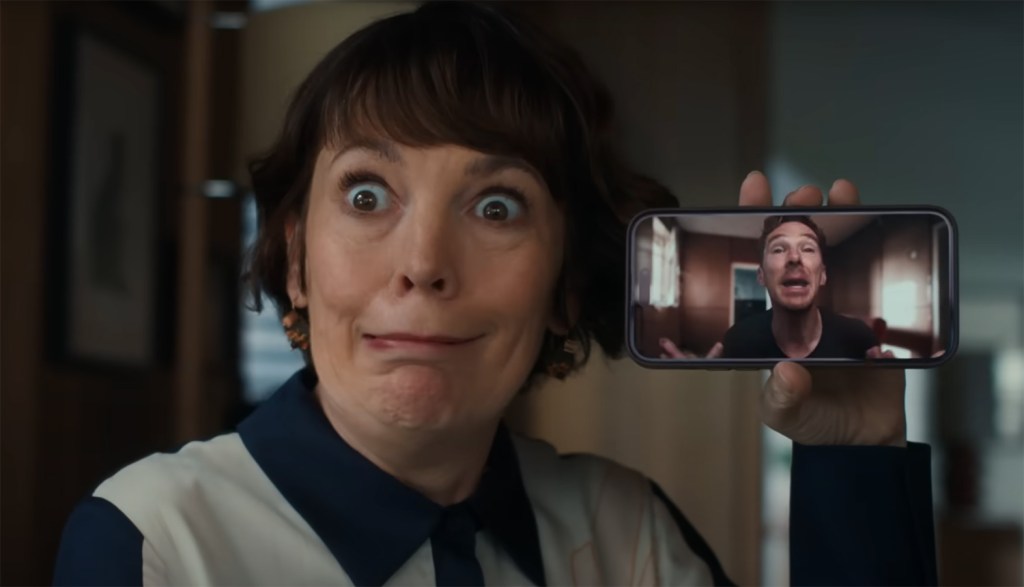 Olivia Colman holding Benedict Cumberbatch on a mobile phone voice call. 