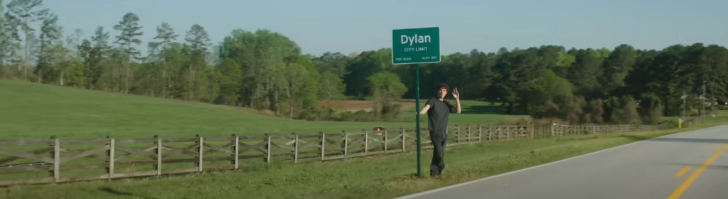 Standing at the town limits. 