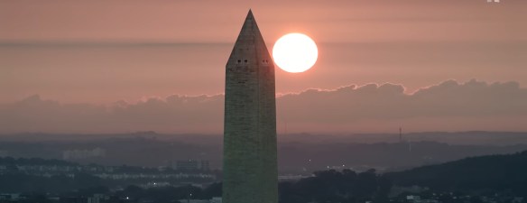 Sun rising behind the Washington Monument.