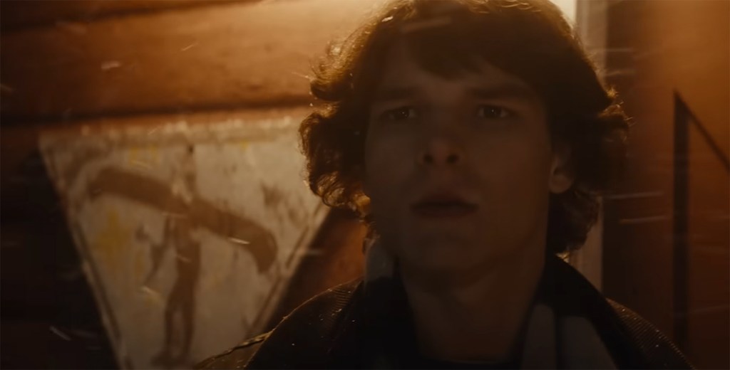 Finney stares out into the snow storm. 