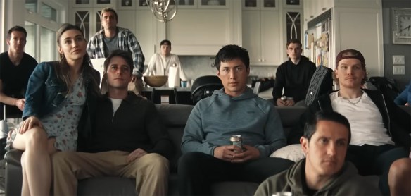 The group watch a hockey match. 