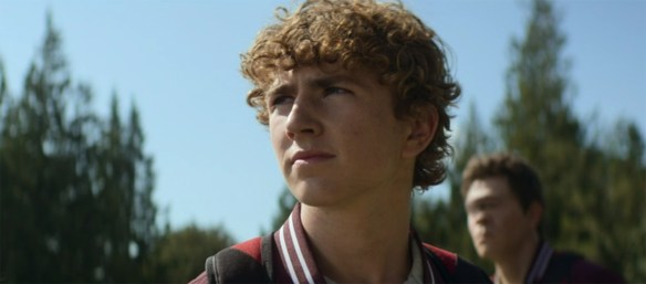 Percy Jackson stands tall. 