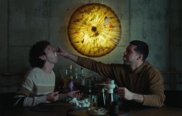 Dennis and Roman stuff their faces with marshmallows. 