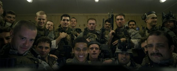 A group of soldiers watching a video.