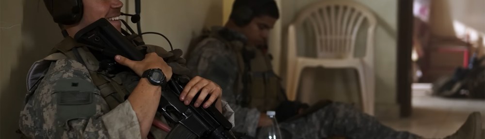 Soldiers sit and wait for the coming conflict.