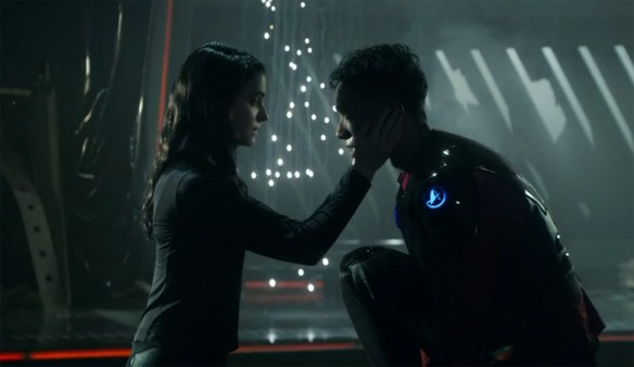 Tarima holds Caleb as sparks explode. 