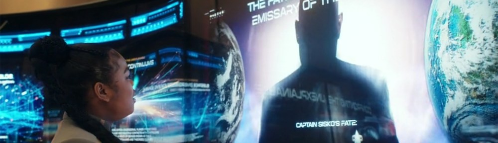 SAM looks at a poster of The Emissary.