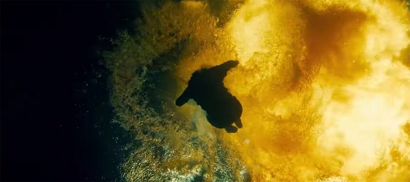 Man falls into water as explosion happens above him.