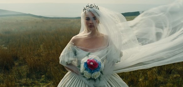 Cathy in a wedding dress flowing along the moors. 