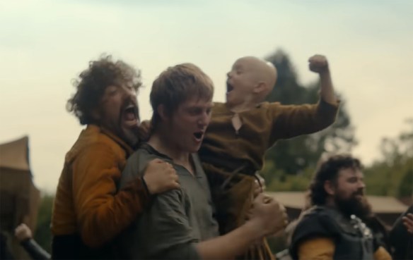 People cheer winning a tug-of-war.