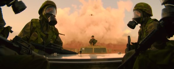 Masked troops drive away from a town being bombed in fire.