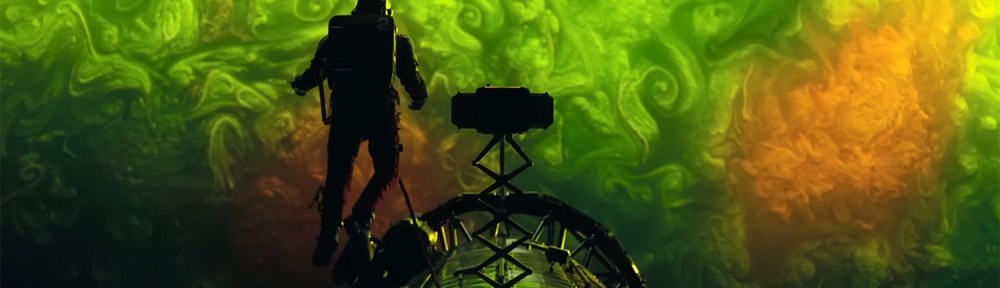 Ryland hangs outside the ship staring down at the atmosphere of the plant below.