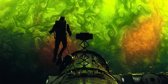 Ryland hangs outside the ship staring down at the atmosphere of the plant below.