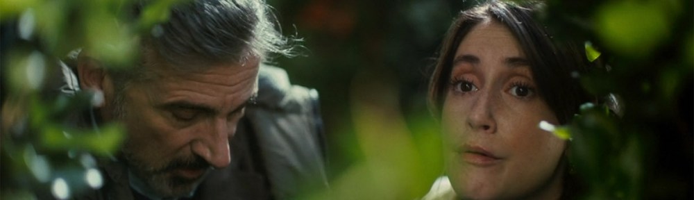 Greg and Katie hiding in bushes.