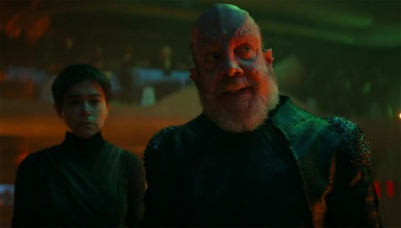 Nus Braka (Paul Giamatti) pontificates. 