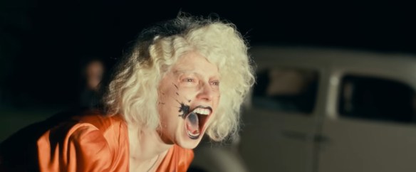 Jessie Buckley as The Bride screaming. 