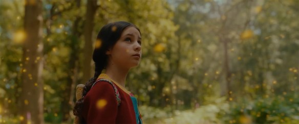 Magic yellow lights float around a girl.