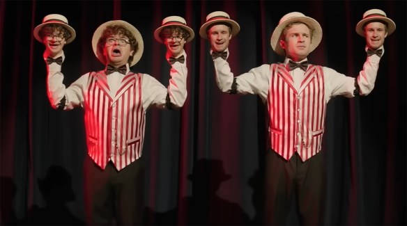 The guys on a drug trip dressed as a barbershop quartet, with singing heads instead of hands.