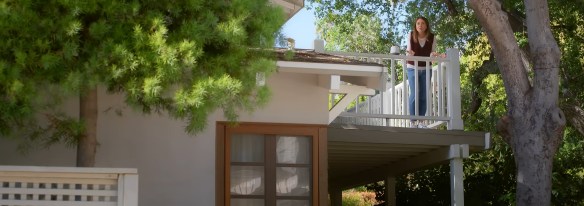 Liz looking down from her balcony. 
