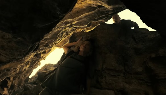 Ben looks down trying to find Sasha hiding under a rock.
