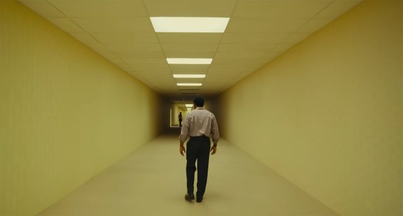 Clarke looks down an almost empty hallway.