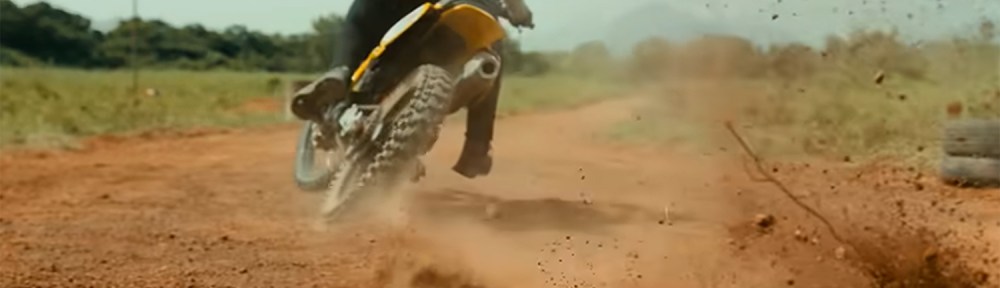 A man ripping up the mud in a motor bike.