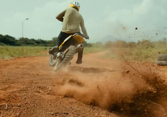 A man ripping up the mud in a motor bike.