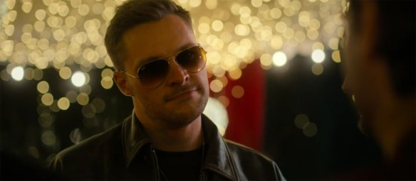 Jack Reynor in sunglasses at night.