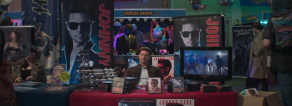 Johnny Cage at a con booth. 